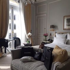 a hotel room with chandelier, couch and bed