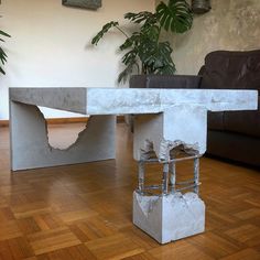 a concrete table sitting on top of a hard wood floor