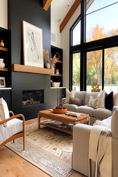 Cozy living room with black fireplace wall and vaulted ceilings. Large Vaulted Living Room, Very Tall Fireplace Wall, Living Room Black White And Wood, Living Room Dark Feature Wall, Diy Fireplace High Ceiling, Dark Toned Living Room, Living Rooms With Black Fireplaces, 20 Ft Fireplace Wall, Black Fireplace Wall Living Room