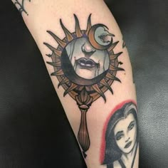 a woman's arm with a sun and moon tattoo design on the left forearm