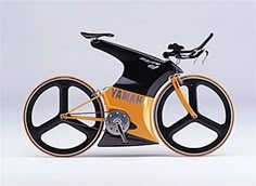 an orange and black bike with wheels on the front is shown in this image, it appears to be made out of plastic