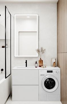 a washer and dryer in a white bathroom