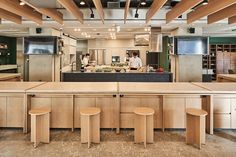 the kitchen is clean and ready to be used for cooking or baking, with stools in front of the counter