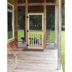 a porch with rocking chairs and a wooden door