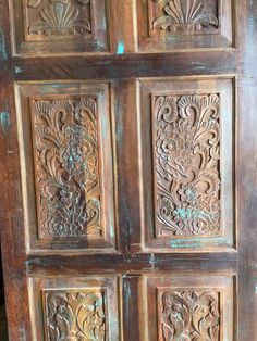 an old wooden door with carvings on it