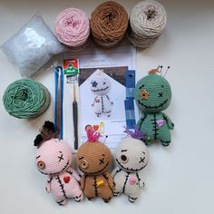 crocheted toys and yarn laid out on top of a table with crafting supplies