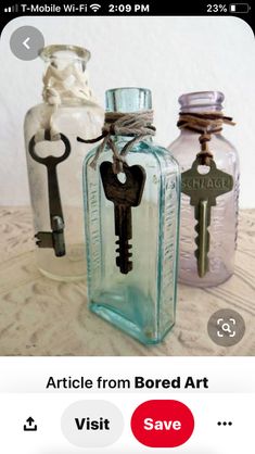 three glass bottles with keys attached to them