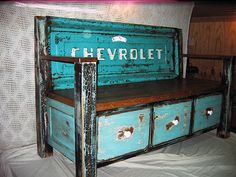 an old blue bench with drawers on it and the word revrolet painted on top