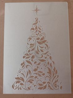 a paper cut christmas tree on a table