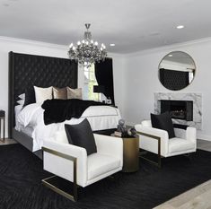 a black and white bedroom with a chandelier