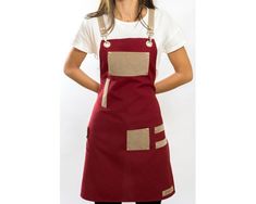 a woman is wearing an apron and has her hands on her hips as she stands in front of a white background