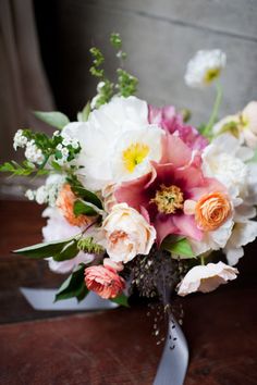 a bouquet of flowers sitting on top of a wooden table