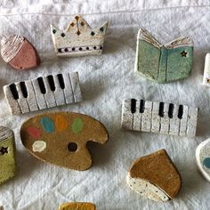 small wooden toys are arranged on a white tablecloth with musical instruments and other items