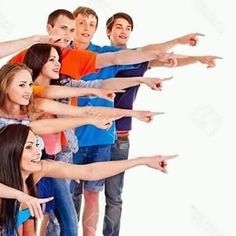 a group of young people standing next to each other with their arms in the air