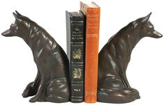 the bookends are made out of metal and have two cats sitting on them