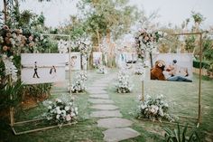 an outdoor ceremony with flowers and pictures