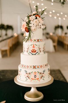 a white wedding cake with flowers on top