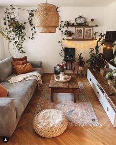 a living room filled with furniture and plants