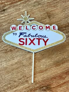 a sign that says welcome to fabulous sixty on it's stick with snowflakes