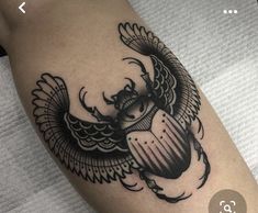 a black and white tattoo on the leg of a woman with an owl in it