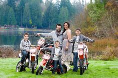 a family posing for a photo with their dirt bikes