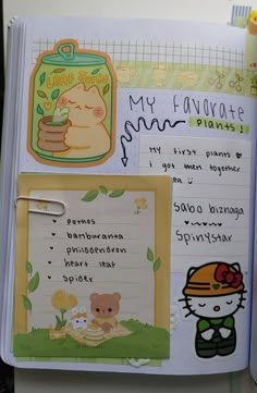 an open notebook with stickers and writing on the pages that include images of cats