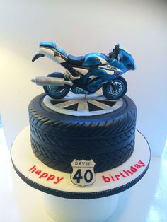 a birthday cake made to look like a motorcycle on top of a tire with the number forty