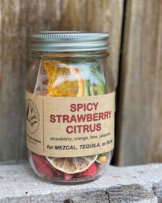 a jar filled with fruit sitting on top of a wooden table