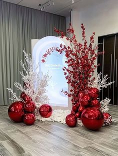 red and white christmas decorations in front of a sign