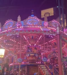 a merry go round at night with lights on