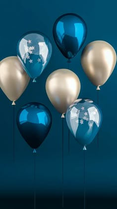 blue and gold balloons are floating in the air with white stars on them, against a teal background