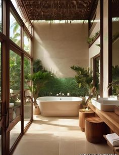 a bathroom with a large tub next to two sinks and windows that look out onto the jungle