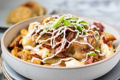 a bowl filled with pasta covered in cheese and toppings