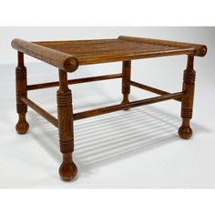 an old wooden table with turned legs and no top is shown in the image on a white background