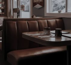 the inside of a restaurant with tables and booths