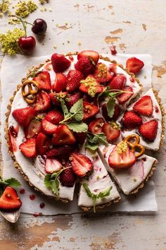 a pie topped with sliced strawberries on top of a table