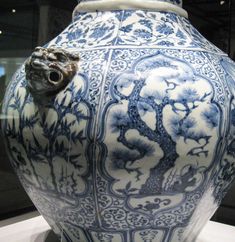 a large blue and white vase sitting on top of a table