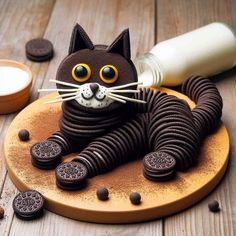 a cat made out of oreos sitting on top of a wooden board next to some cookies