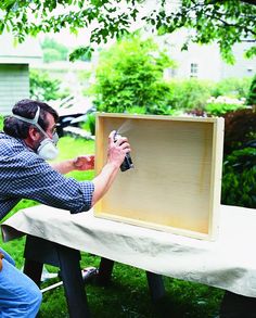 two men are working on a box in the yard