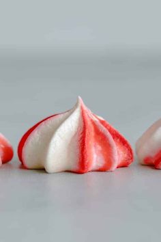 three red and white pieces of food on a table