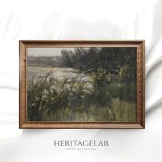 a painting hanging on the side of a wall next to a white bed spread and pillows