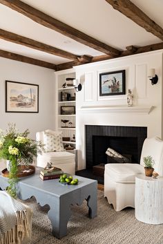 a living room filled with furniture and a fire place next to a white fireplace mantel