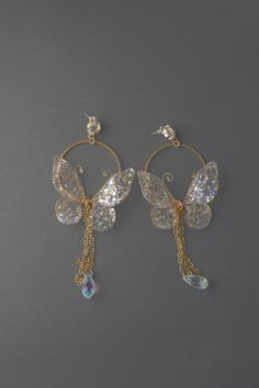 "Butterfly Gold Hoop Earrings UV resin Dangle Earrings These earrings can be a great addition to both a wedding dress and casual wear, relatively small size and perfectly combined with a dress and a suit    ♥ Love it and want to buy later? Click on the heart to your right that says \"Favorite.\" ♥ Want it now? Click the green \"Add to cart\" button. ♥ Want it now fast? Check our UPS delivery terms. https://www.etsy.com/listing/720565399/flower-fairy-express-delivery-with-ups-3 ♥ View more earrings; https://www.etsy.com/shop/FairyFlowerJewelry?section_id=28072613 ♥ Questions about how to buy? http://www.etsy.com/help_guide_checkout.php ♥ Special request, customer order, or you just have a question for me? https://www.etsy.com/messages/new?with_id=141499540&referring_id=17183496&referring_ty Diamond Earrings Aesthetic, Inexpensive Jewelry, Magical Jewelry, Party Earrings, Fancy Jewellery, Fancy Jewelry, Fashion Jewelry Earrings, Fantasy Jewelry, Girly Jewelry