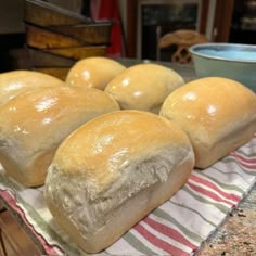 several loaves of bread sitting on top of a towel