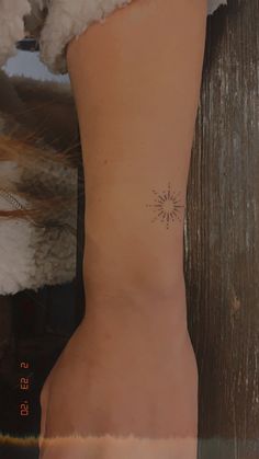 a person with a small tattoo on their left arm and the back of her leg