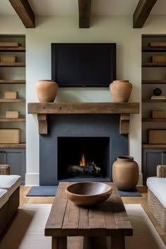 a living room filled with furniture and a fire place in front of a flat screen tv