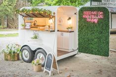 the food truck is decorated with flowers and greenery