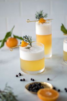 two glasses filled with orange juice and garnish