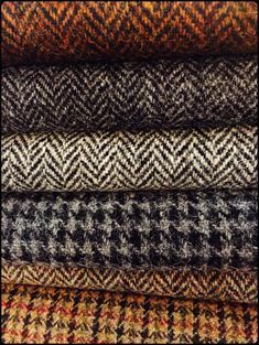 a pile of different colored tweed fabric