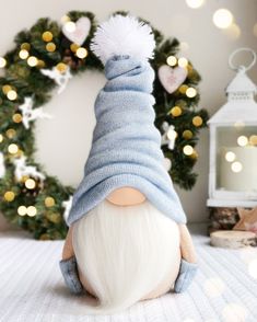 a stuffed gnome with a blue sweater and white hair